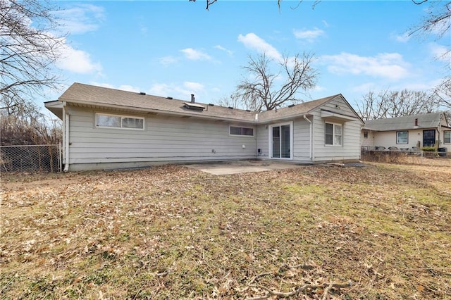 back of property with a patio and a lawn