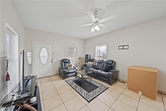 tiled living room with ceiling fan