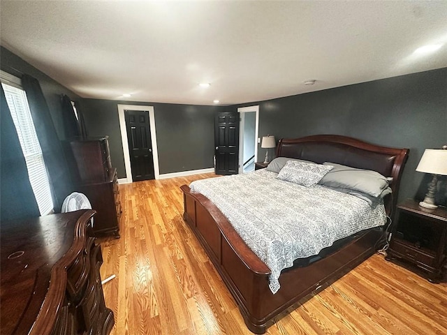 bedroom with light wood-style flooring and baseboards