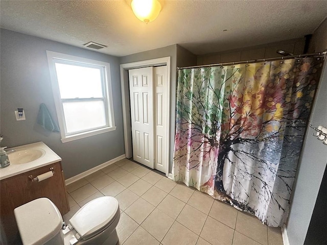 full bathroom featuring tile patterned flooring, baseboards, vanity, and a textured ceiling