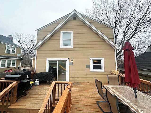 deck featuring a grill and outdoor dining area