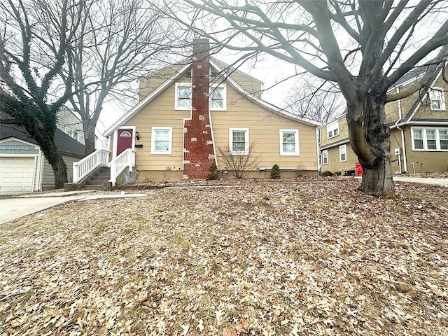 view of front of house with an outbuilding and a chimney