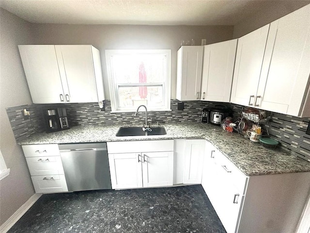 kitchen with light stone counters, white cabinetry, a sink, and stainless steel dishwasher