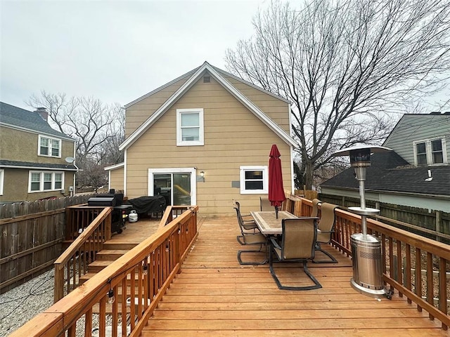 wooden deck featuring outdoor dining area and fence