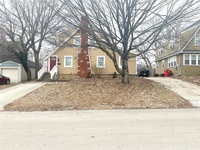 view of front of home with concrete driveway and a chimney