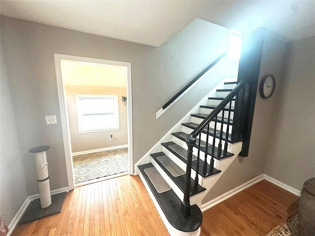 stairs featuring baseboards and wood finished floors