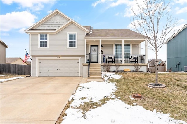 tri-level home with a yard, covered porch, a garage, and central AC