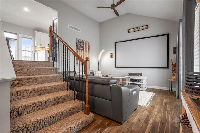 cinema room featuring ceiling fan, lofted ceiling, and dark hardwood / wood-style flooring