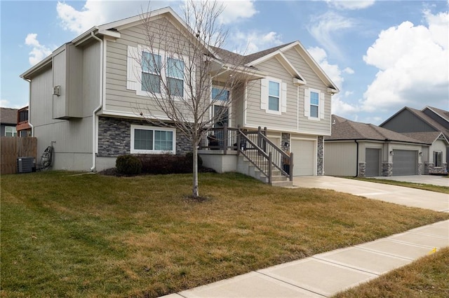 view of front of house featuring a garage, central AC, and a front yard