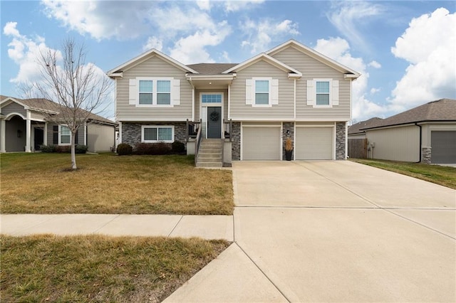 raised ranch featuring a garage and a front lawn