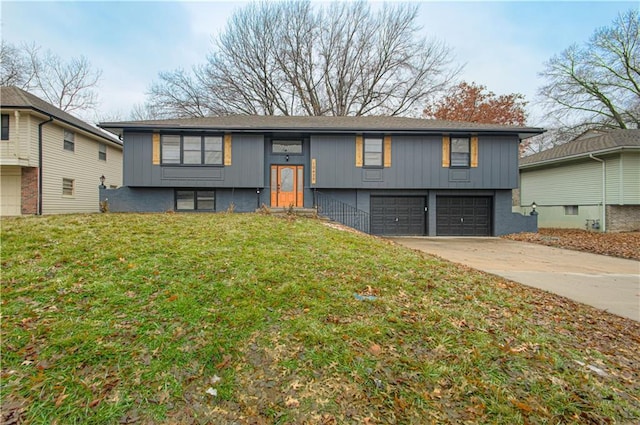 raised ranch featuring a garage and a front lawn