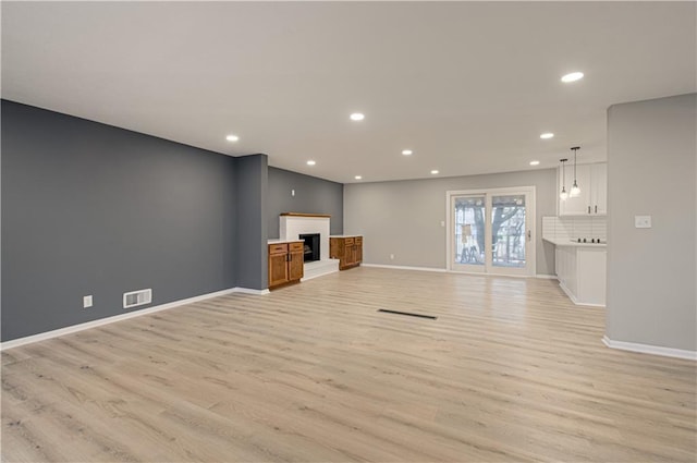 unfurnished living room featuring light hardwood / wood-style floors