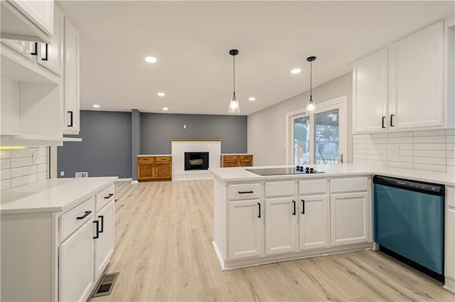 kitchen featuring white cabinetry, dishwasher, a brick fireplace, and black electric stovetop