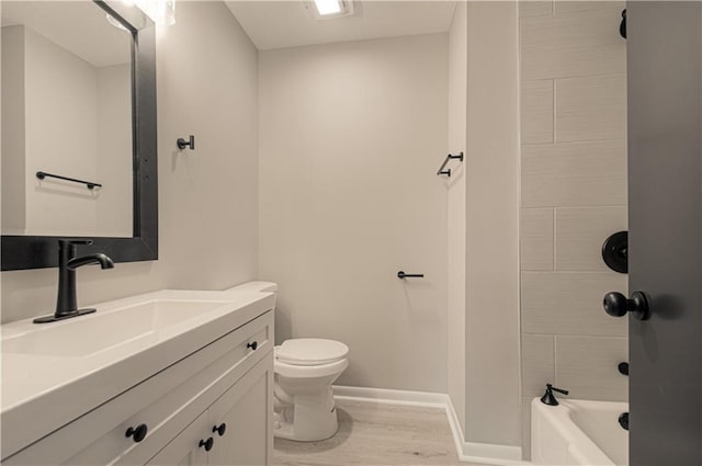 bathroom featuring vanity, toilet, and hardwood / wood-style floors