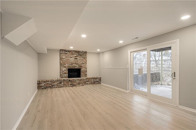 unfurnished living room featuring light hardwood / wood-style flooring and a fireplace