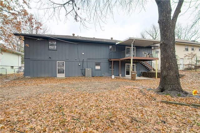 back of house featuring a wooden deck and central AC