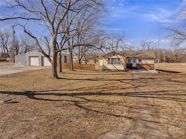 view of front of home with a garage and an outdoor structure