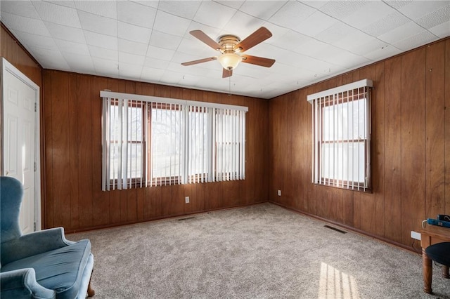 sitting room featuring ceiling fan, light colored carpet, and a healthy amount of sunlight