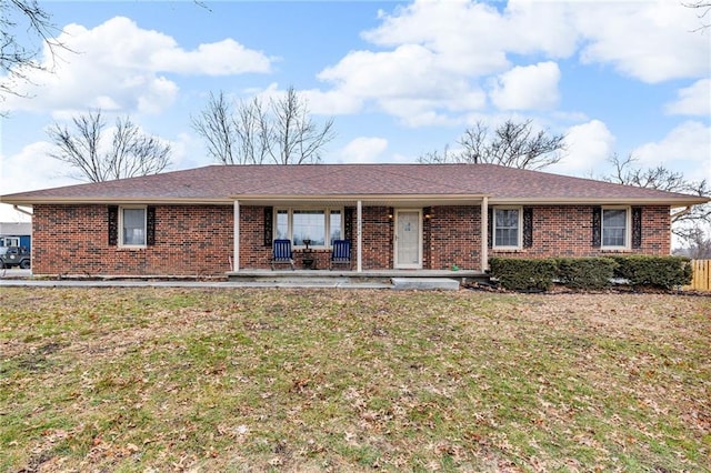 single story home with a front yard and covered porch