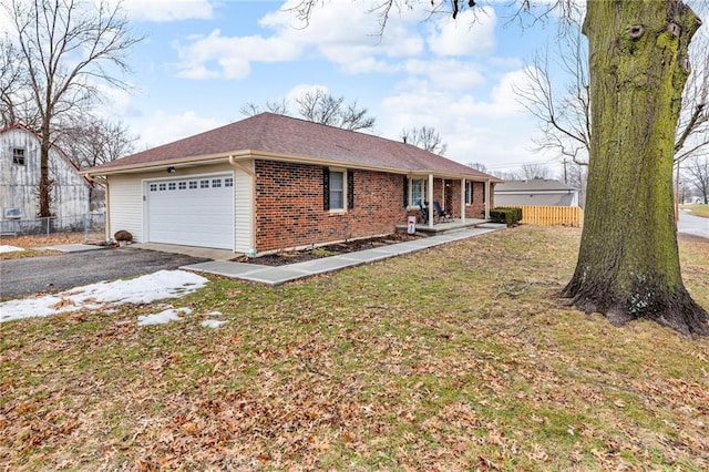 view of front of property featuring a garage and a front lawn