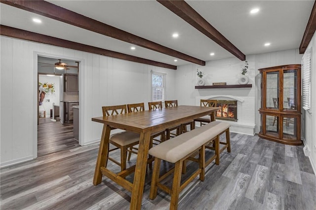 dining area featuring beam ceiling and hardwood / wood-style floors