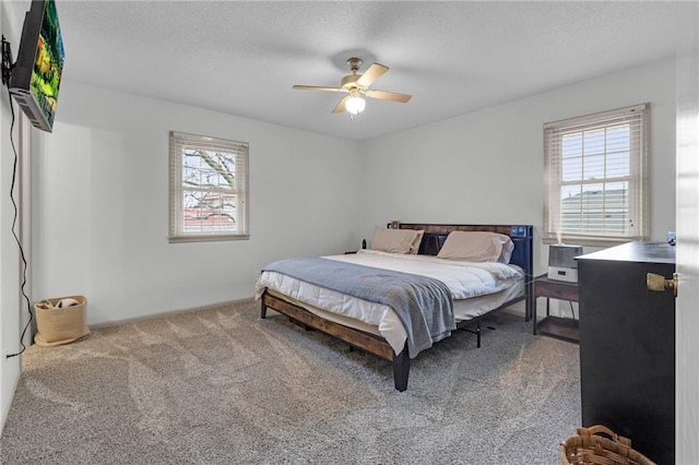 bedroom with multiple windows, carpet floors, and ceiling fan