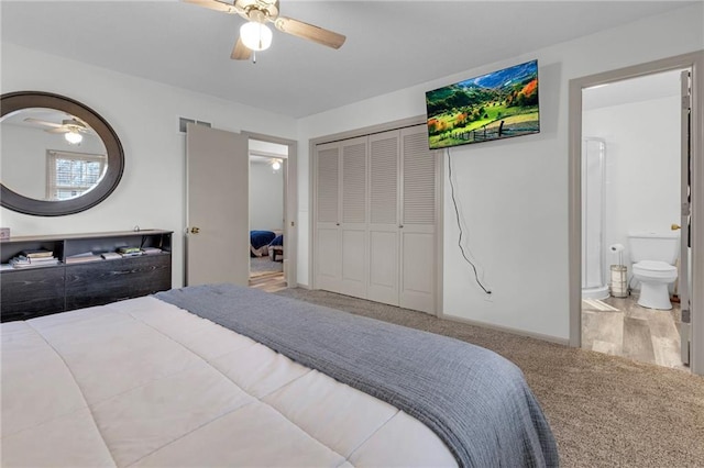 bedroom with ceiling fan, light colored carpet, ensuite bathroom, and a closet