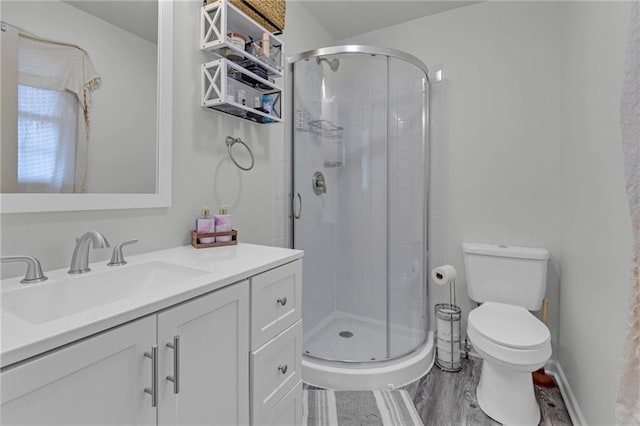 bathroom featuring vanity, an enclosed shower, hardwood / wood-style floors, and toilet