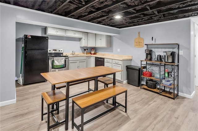 kitchen featuring sink, black appliances, and light hardwood / wood-style floors