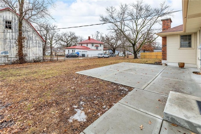 view of yard with basketball hoop