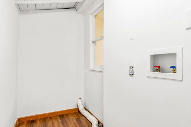 washroom with wood-type flooring and hookup for a washing machine