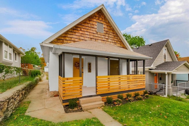 view of front facade with a front yard and a porch