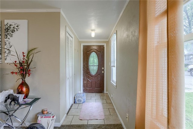 doorway to outside featuring a healthy amount of sunlight, baseboards, and ornamental molding