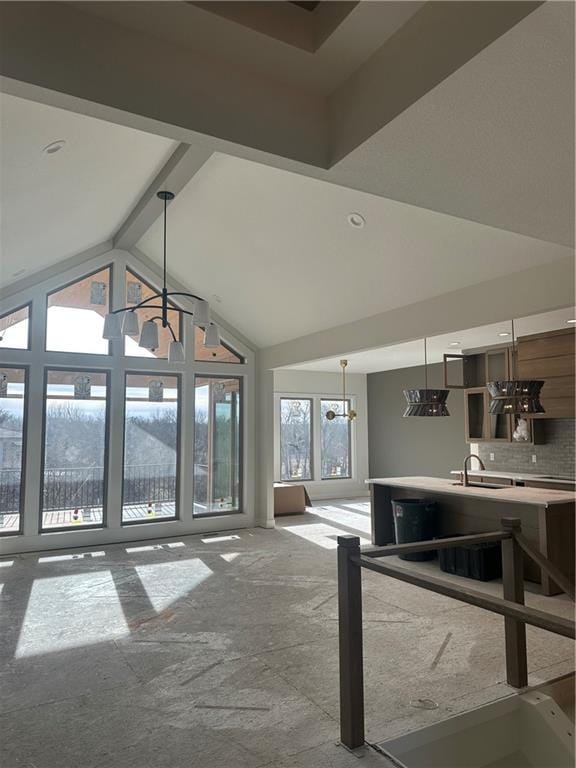 living room with lofted ceiling with beams and sink