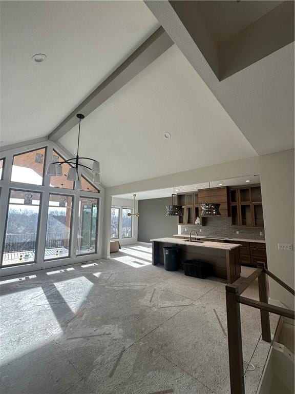 living room featuring beam ceiling and high vaulted ceiling