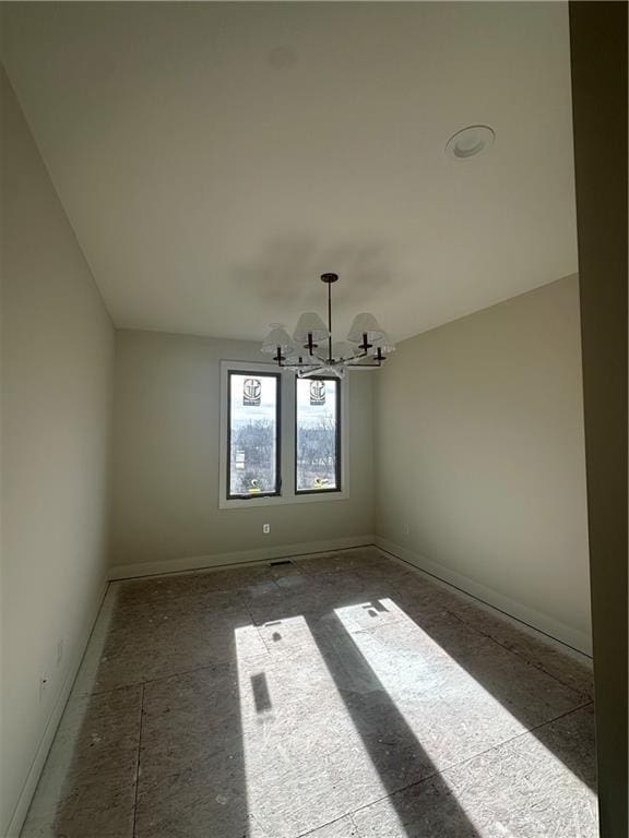 spare room with an inviting chandelier