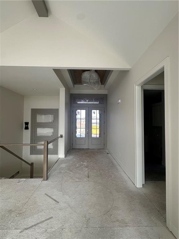 foyer with lofted ceiling with beams and french doors