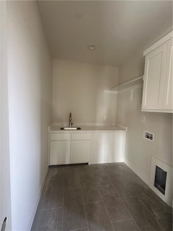 washroom featuring cabinets, hookup for a washing machine, and sink