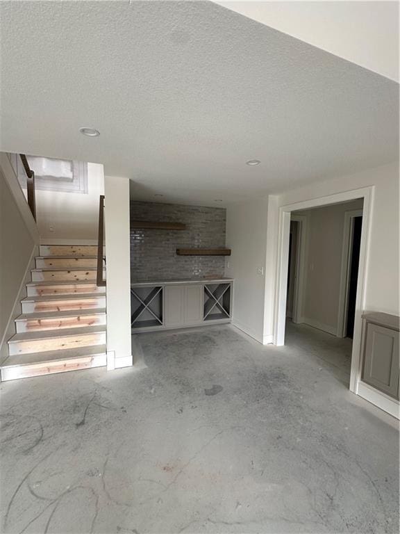 unfurnished living room with a textured ceiling