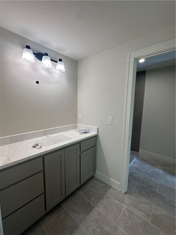 bathroom with vanity and a textured ceiling