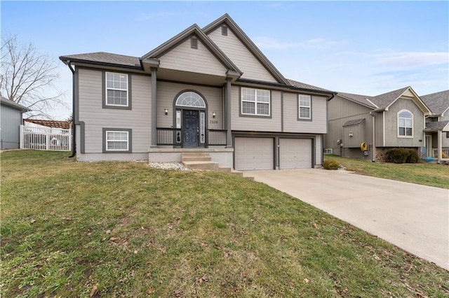 raised ranch with a garage and a front lawn