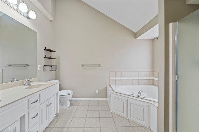 bathroom with vaulted ceiling, vanity, a washtub, toilet, and tile patterned floors