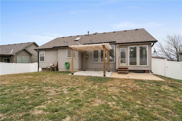 rear view of property with a yard, a pergola, and a patio