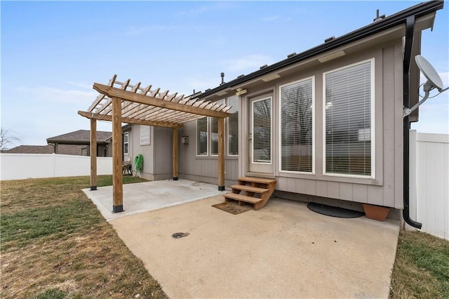 rear view of house with a pergola, a patio area, and a lawn