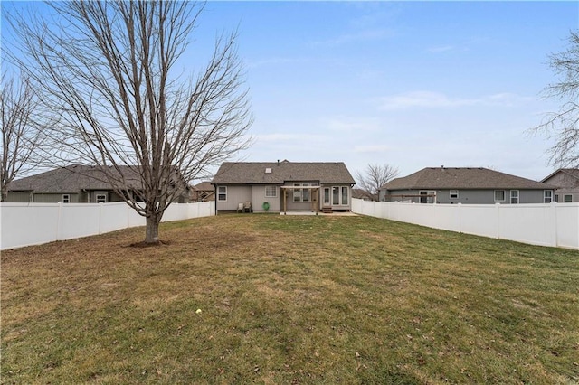 back of house featuring a lawn