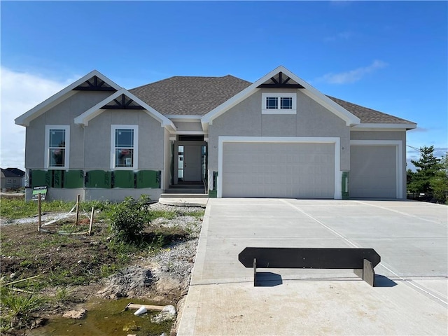 16577 W 165th Pl, Olathe, KS 66062 - view of front of property with an attached garage, stucco siding, driveway, and roof with shingles