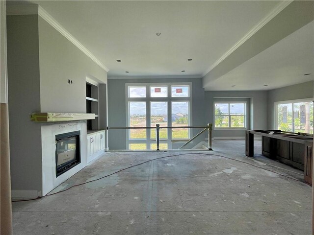 16577 W 165th Pl, Olathe, KS 66062 - unfurnished living room with ornamental molding, built in features, and a glass covered fireplace