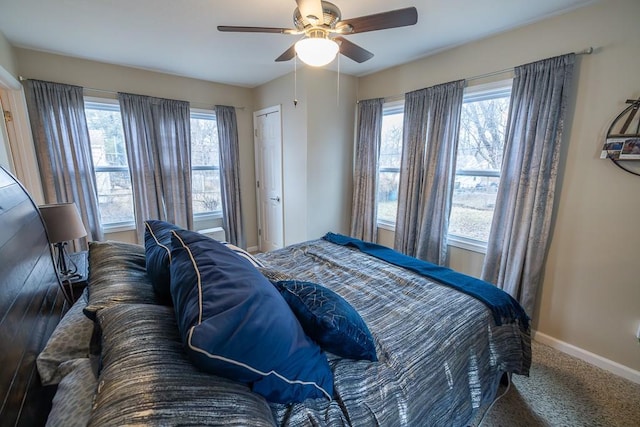 bedroom featuring ceiling fan, multiple windows, and carpet