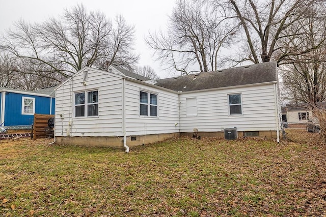 back of property featuring a yard and central air condition unit