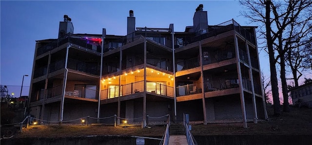 view of back house at dusk